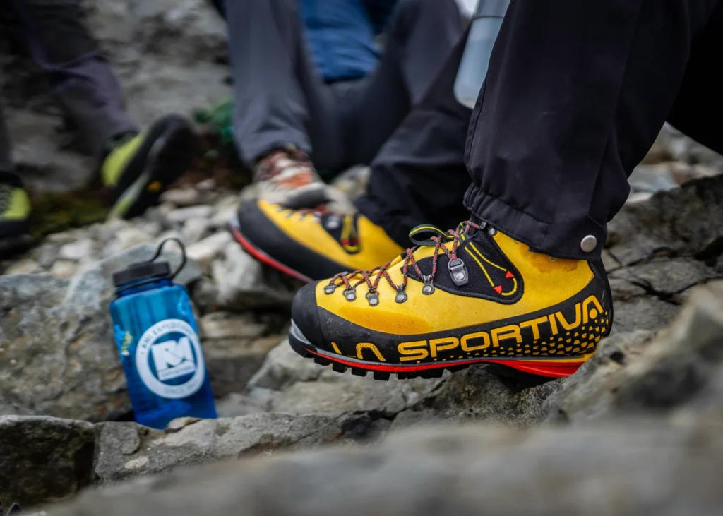 La Sportiva Nepal Trek EVO GTX boots on rocky Himalayan terrain showing stiff sole trekking boots and crampon compatible boots for Himalaya expeditions